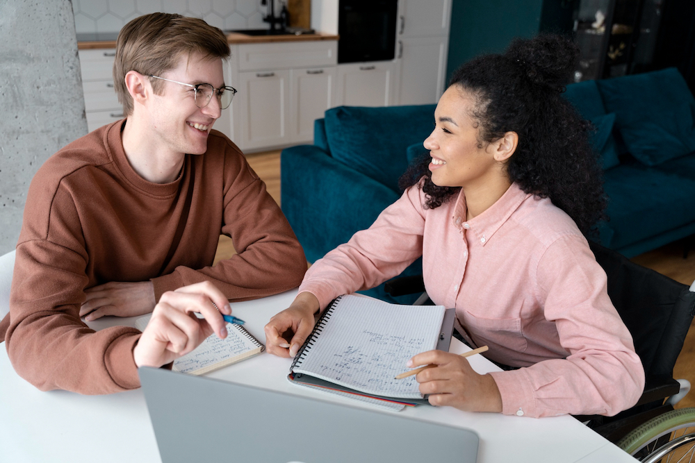 An ESL teacher motivating a student during a conversation class.