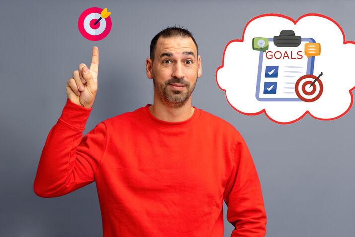 A young man thinking about his personal goals, planning how to achieve them for an ESL lesson on setting goals.