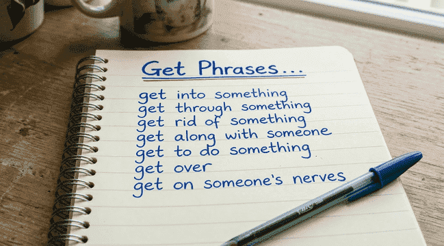 Notebook with handwritten “get” phrases showing common get phrasal verbs for an ESL lesson plan, including get into, get through, get rid of, and get along