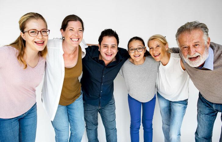 Smiling group of people of different ages standing together, ideal for teaching numbers and age in an ESL lesson plan