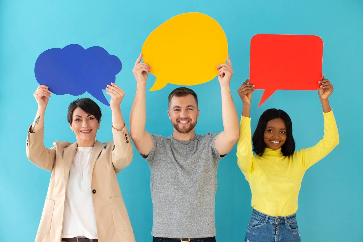 Three ESL students holding colorful speech bubbles for a giving opinions ESL lesson plan on discussion phrases and speaking skills.